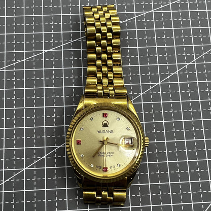 38mm Wudang Steel mechanical watch with golden dial and single calendar, 17 jewels, elegant design.