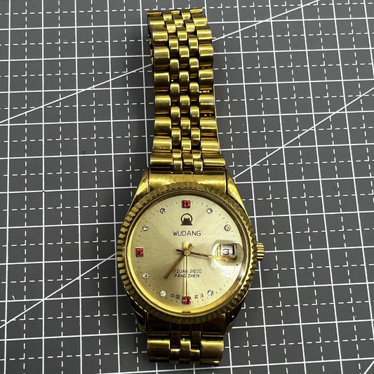 38mm Wudang Steel mechanical watch with golden dial and single calendar, 17 jewels, elegant design.