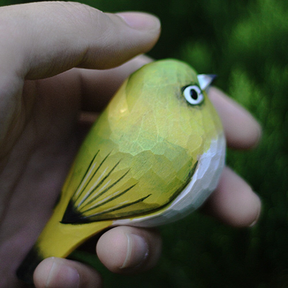 Handmade white-eye bird wooden figurine, charming decorative art for home or office display.