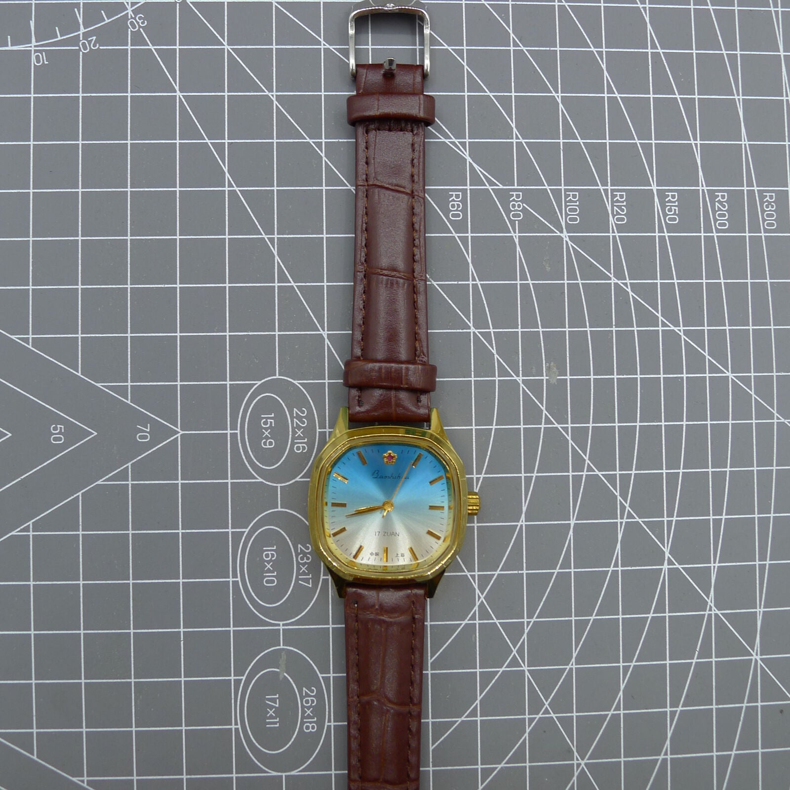 33mm Shanghai watch with blue dial, golden nail markers, square case, manual movement by Shanghai brand.