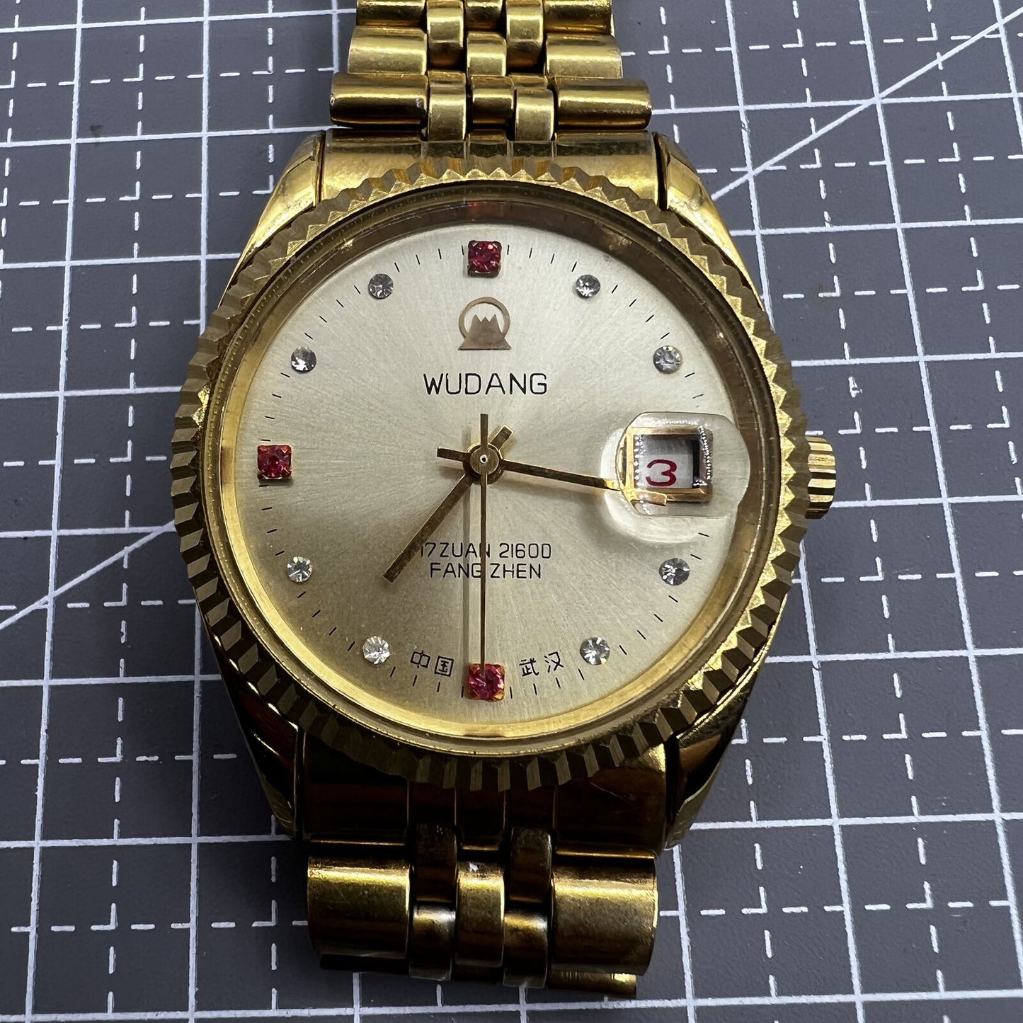 38mm Wudang Steel mechanical watch with golden dial and single calendar, 17 jewels, elegant design.