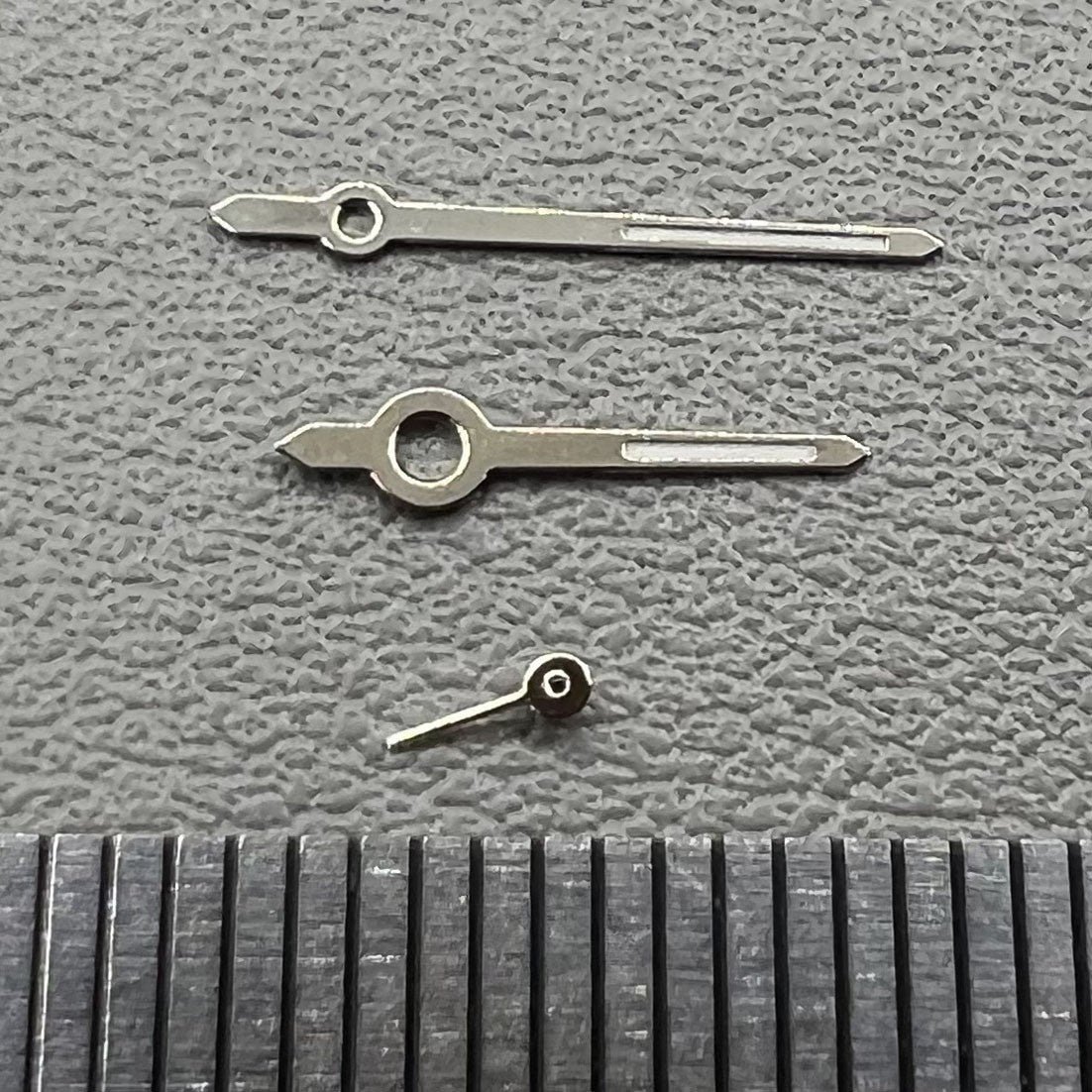 Set of 2 silver trim green luminous watch hands for Miyota 1L45 movement, 11mm length, brand quality.