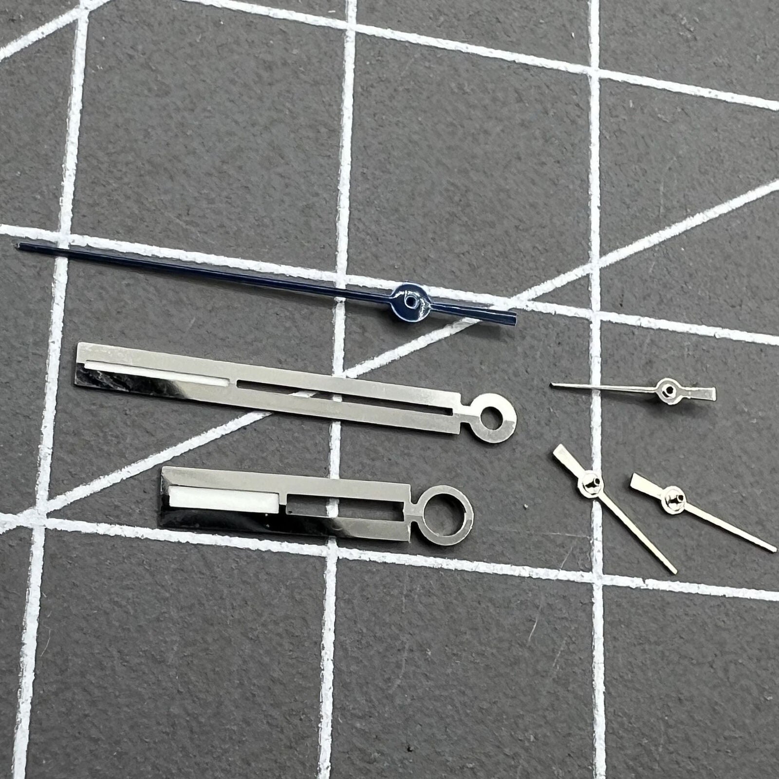 Silver luminous watch hands for Ronda 5021D, enhancing low-light readability on watch dials.