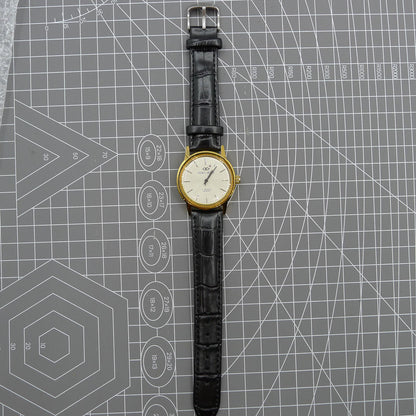 Beijing Double Rhomb watch with golden case, silver nail markers, and manual mechanical movement for classic style.