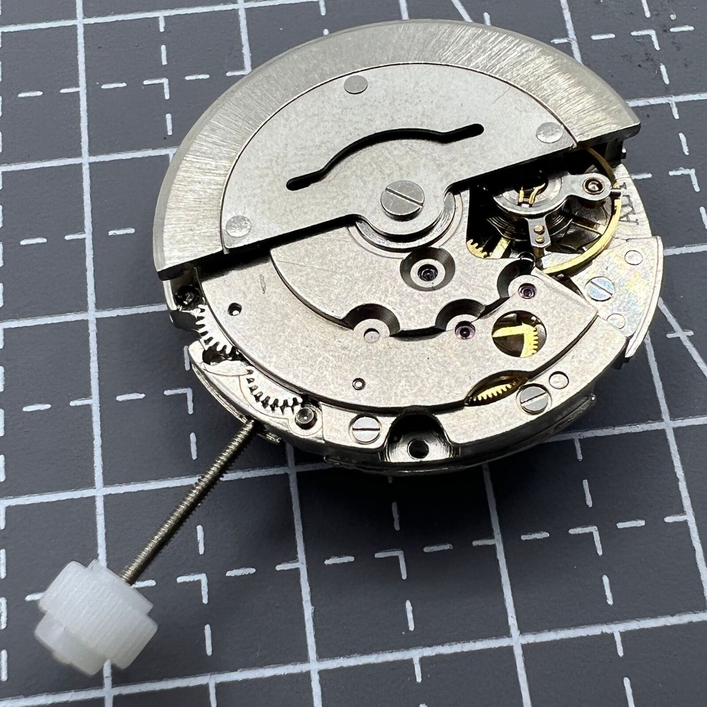 Close-up of China Made 2813 mechanical watch movement displaying date at 3 o'clock, precise timekeeping component.
