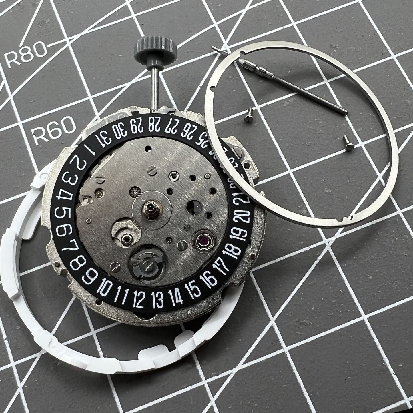 Miyota Citizen 8215 automatic watch movement with black dial and date at 6 o'clock, Japan-made.