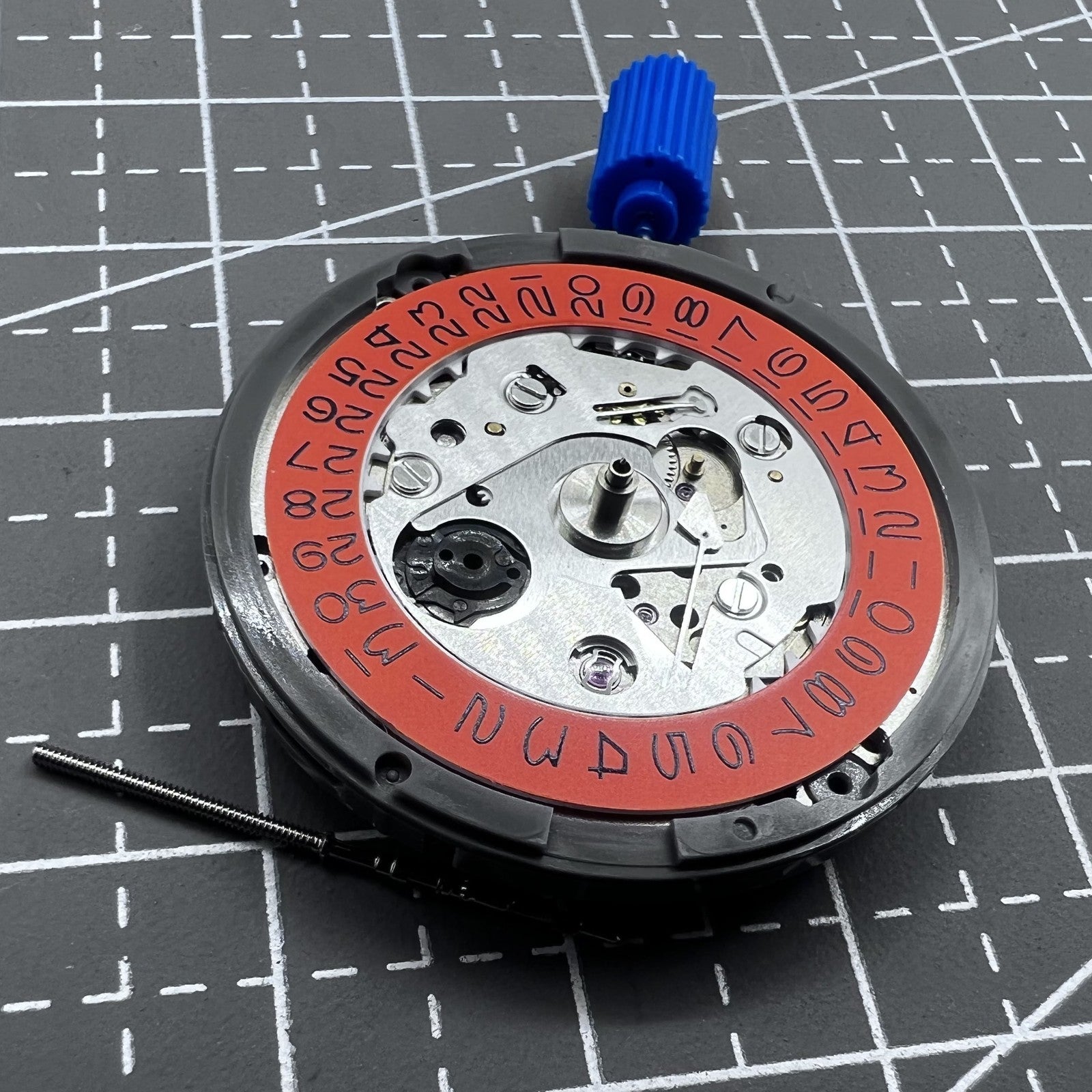 Seiko NH35 automatic watch movement with high precision and vibrant orange dial, ideal for watch repairs.