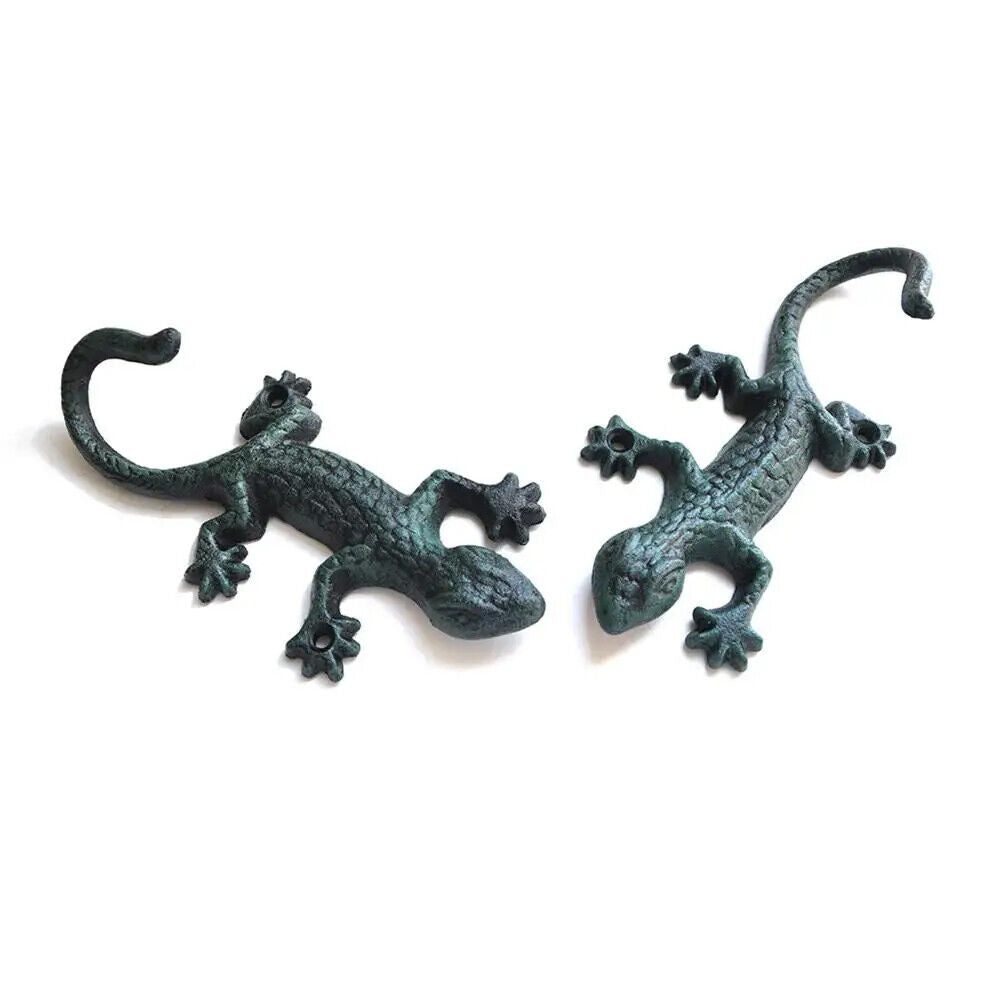 Vintage cast iron gecko-shaped wall hook for hanging cloth or garden tools, durable and rustic.