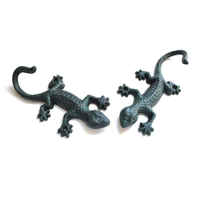 Vintage cast iron gecko-shaped wall hook for hanging cloth or garden tools, durable and rustic.