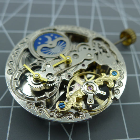 Automatic mechanical watch with silver 3 hands, hollow moon phase display at 12 o'clock.