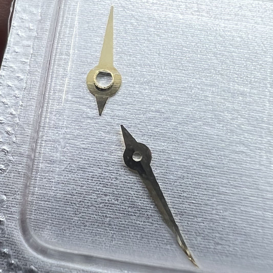 Golden watch hands set with hour, minute, and second hands for 976.001 movement.