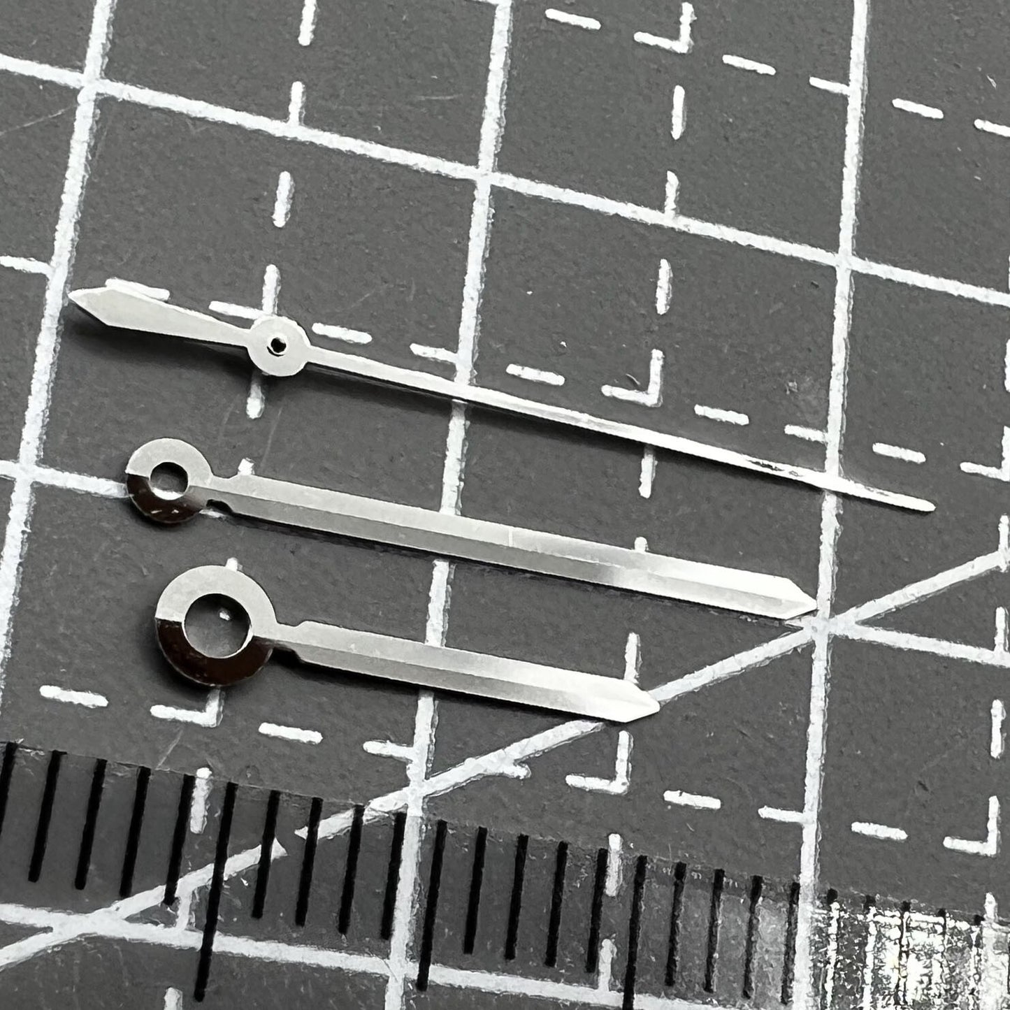Silver watch hands set for ETAC07.111 movement, compatible with T099 watch, precision design.