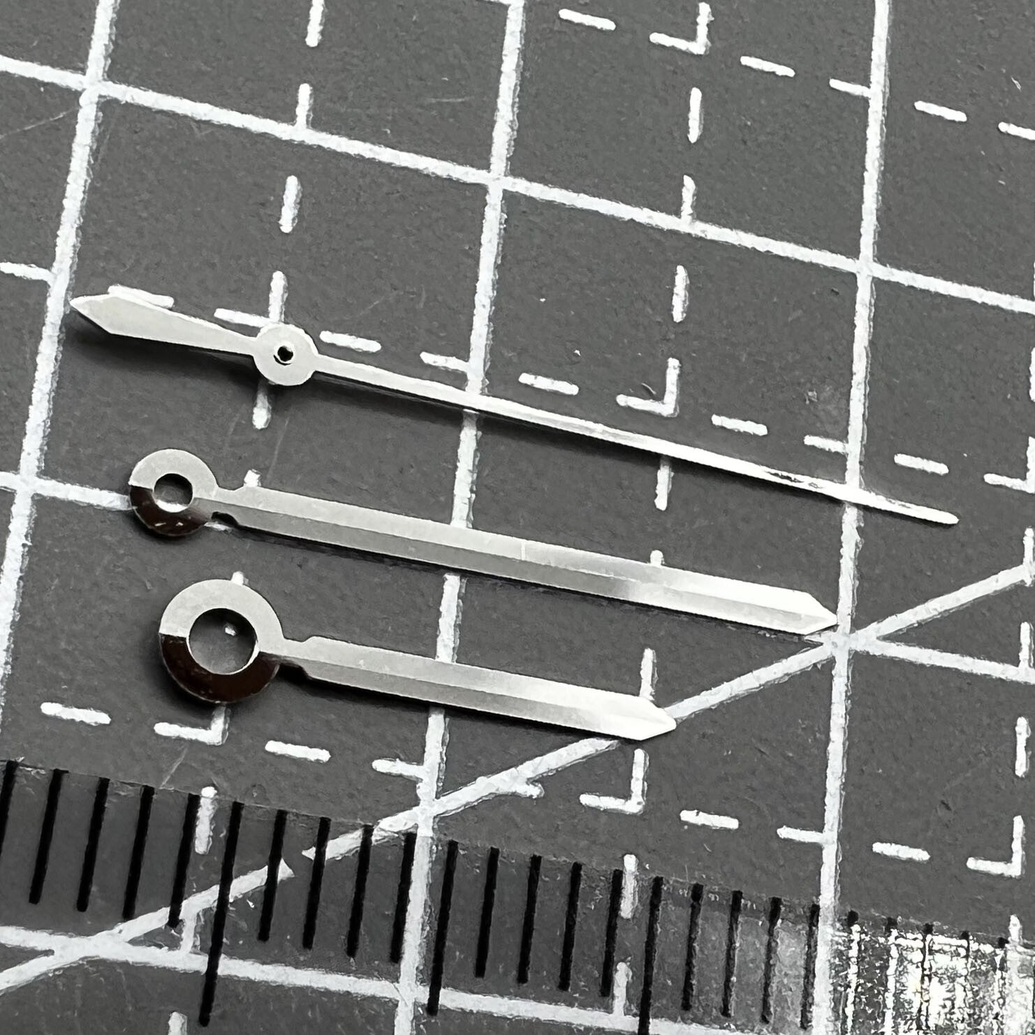 Silver watch hands set for ETAC07.111 movement, compatible with T099 watch, precision design.