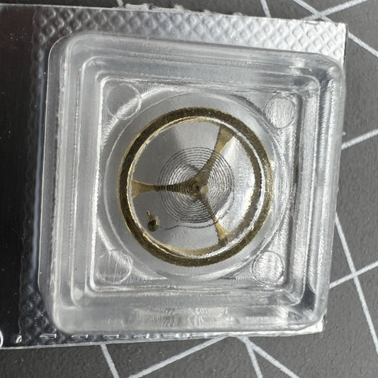 Golden balance wheel with hairspring for Orient 46941 46943 watch movement, precision timing component by Orient.