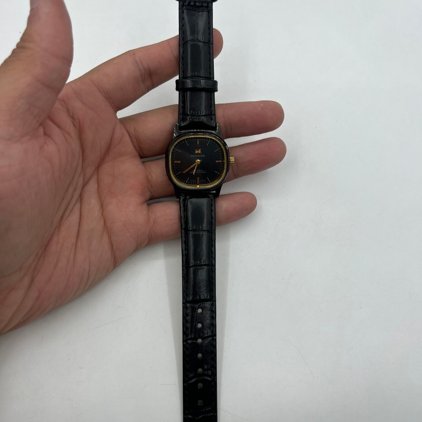 Shanghai Factory 34mm manual mechanical watch with black dial, 19 jewels, shock-resistant design.
