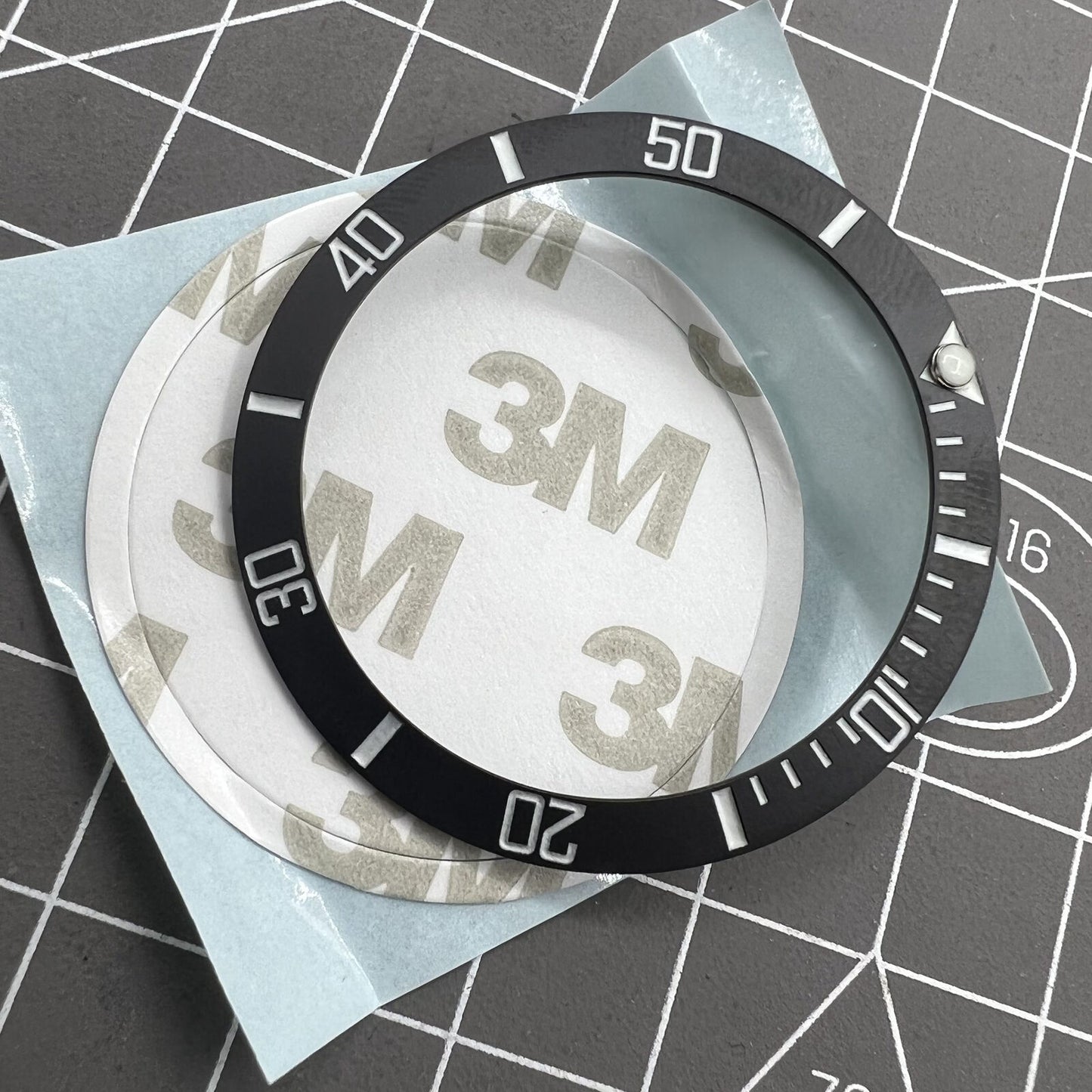 38mm ceramic watch bezel with black slope, silver font, and blue luminous details for watch accessories.