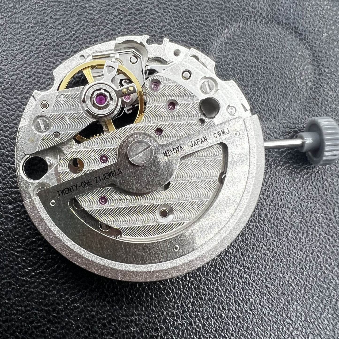 Miyota 82S0 silver hollow automatic mechanical movement, precise watch accessory for repair and customization.