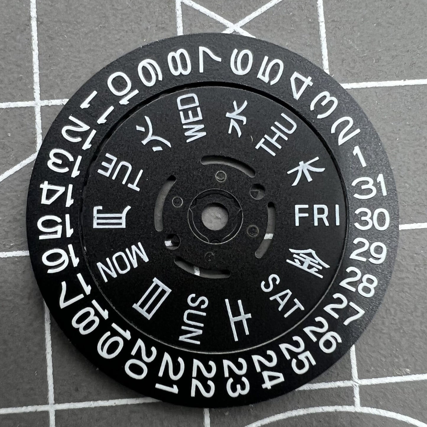 Blue Lume black date and week disk wheel for NH36 movement, enhancing watch accessory functionality.