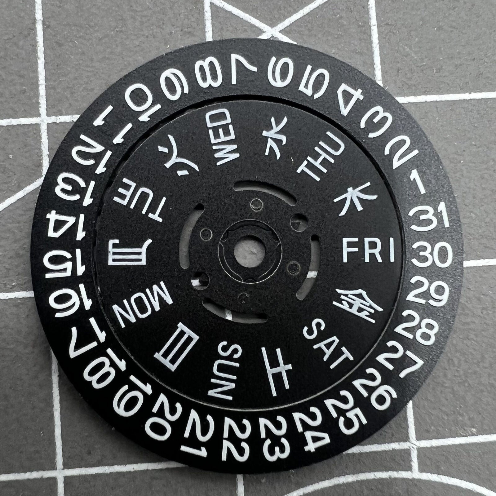 Blue Lume black date and week disk wheel for NH36 movement, enhancing watch accessory functionality.