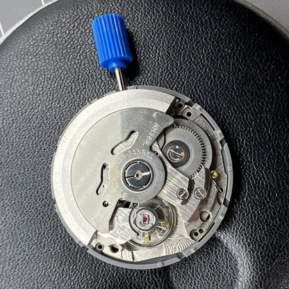 Miyota NH36A black-finished watch movement with green lume and 3-position crown for accurate time adjustment.