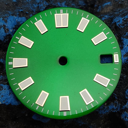 Green luminous watch dial with silver and golden nail trim, compatible with NH35 movement, for elegant timepieces.
