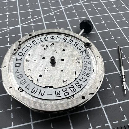 Miyota 9110 automatic watch movement showing date display at 3 o'clock, precision mechanical part.