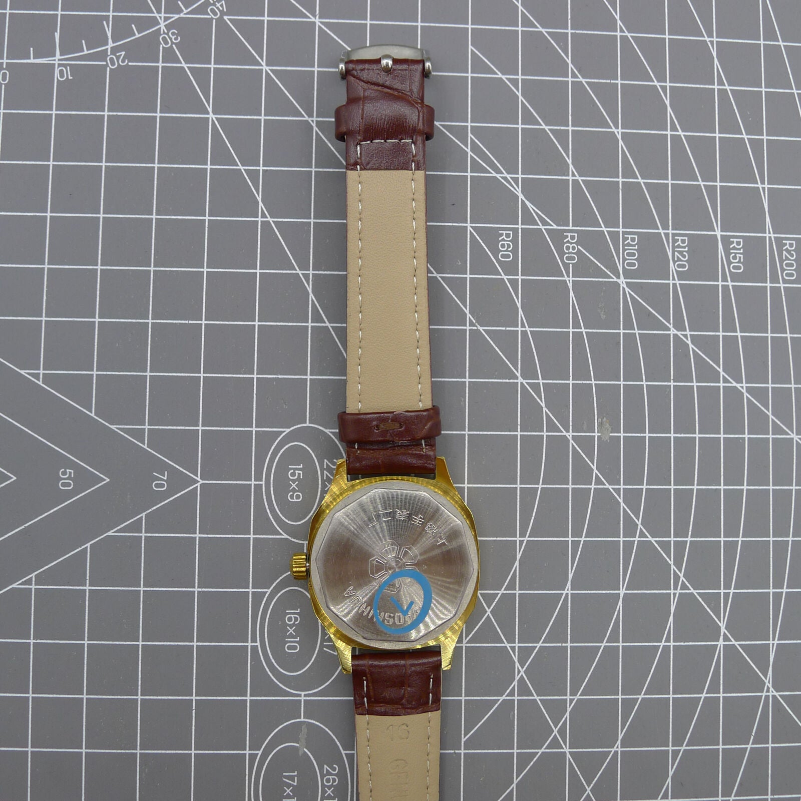 33mm Shanghai watch with blue dial, golden nail markers, square case, manual mechanical movement, 17 jewels by Shanghai.