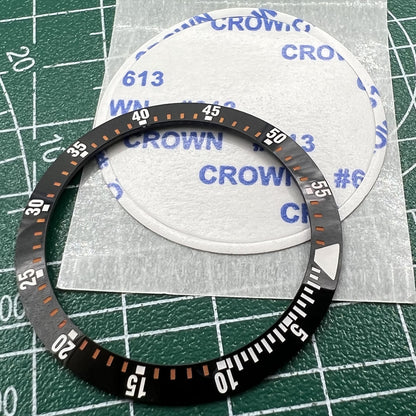 Wholesale black ceramic watch bezel insert with orange graduation, 38mm/30.5mm, ideal for watch repairs and customization.