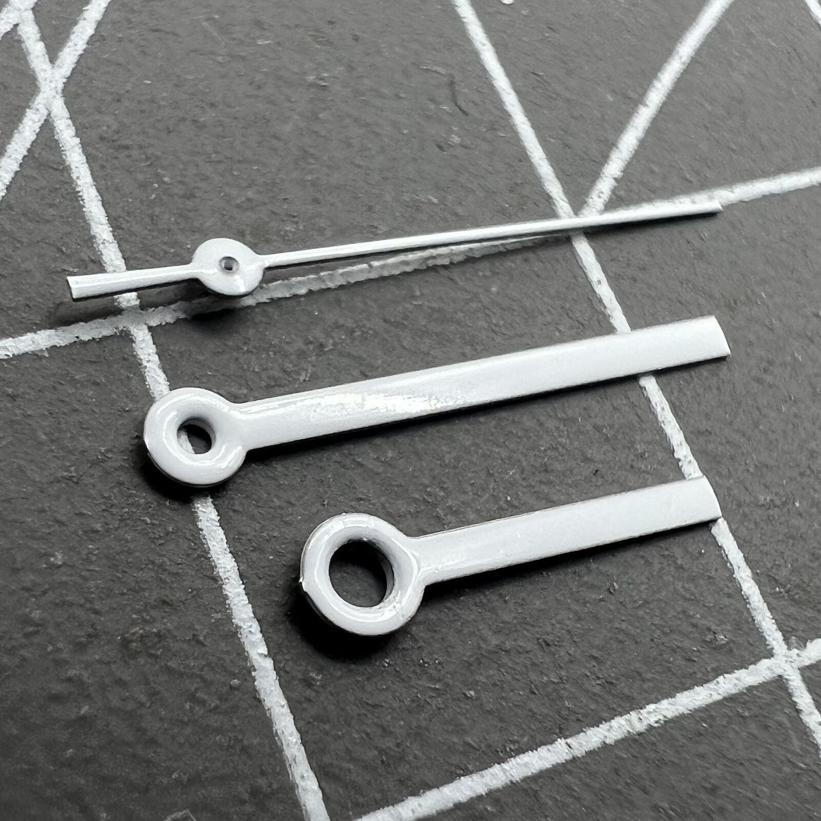 White watch hands set by Miyota, 15x13x9mm, compatible with 2035, 2115, 2105, 2305, 2315 movements, precise accessory for watch repair.