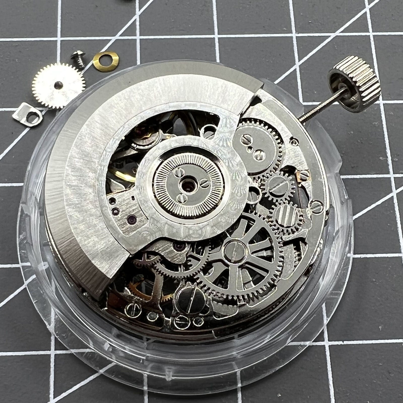 Tianjin Seagull ST25 silver automatic watch movement displaying hollow 3-hand mechanical design.