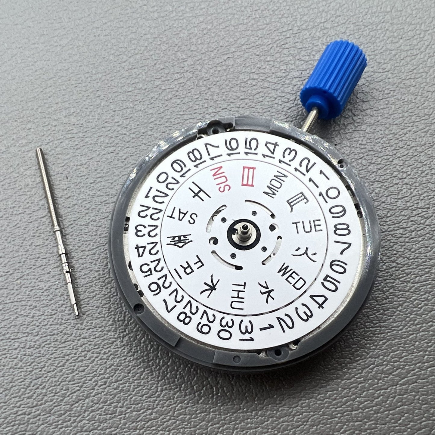 Seiki NH36 watch movement with white dial, featuring Japanese-English day display for precision timekeeping.