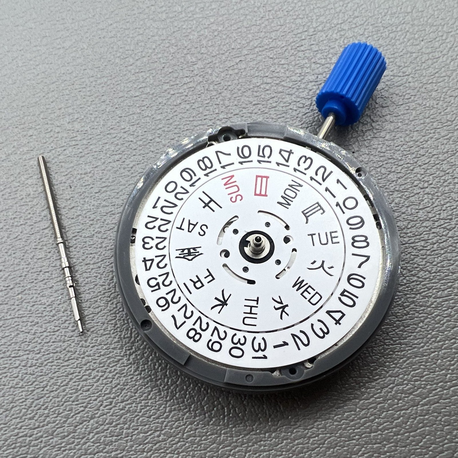 Seiki NH36 watch movement with white dial, featuring Japanese-English day display for precision timekeeping.