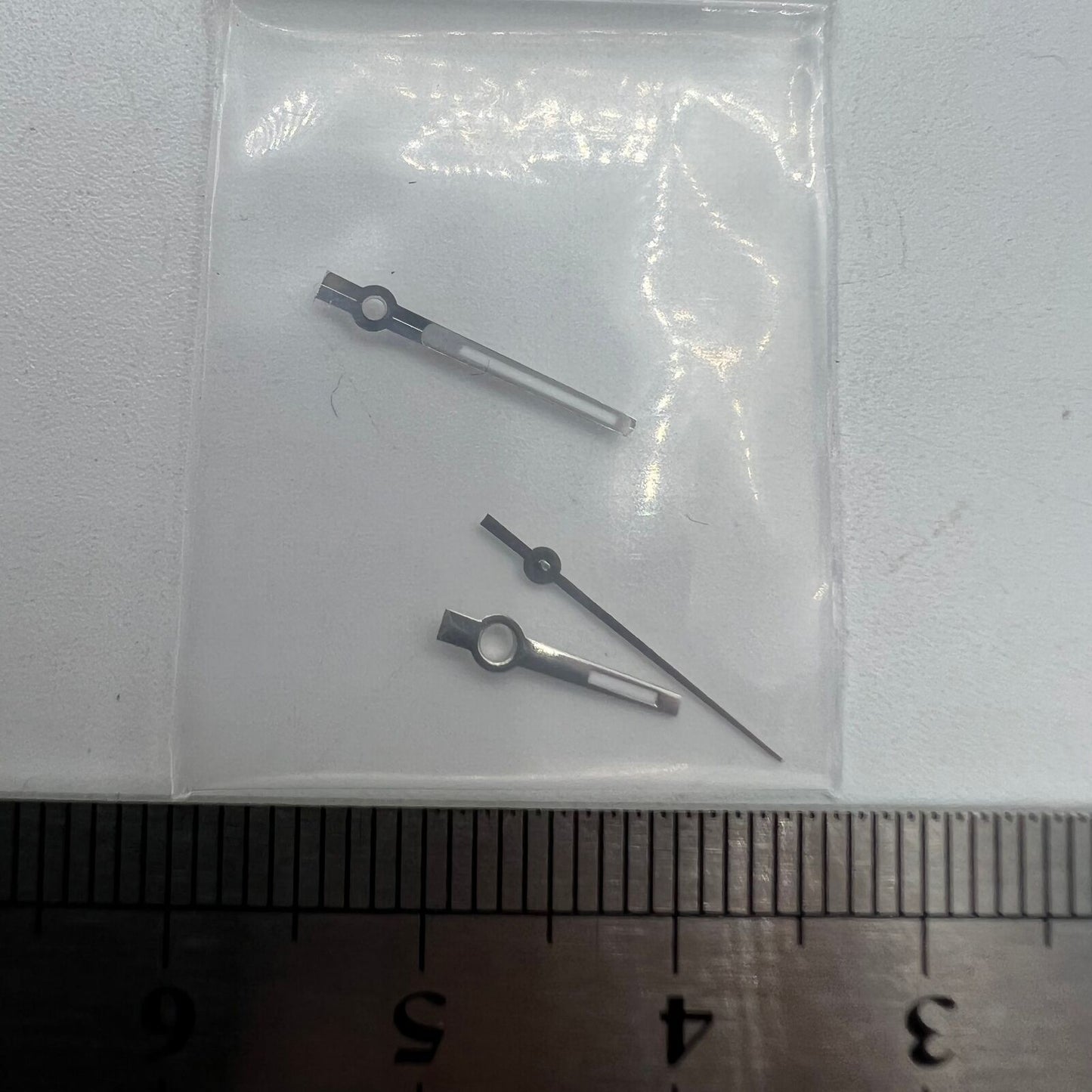 Green luminous watch hands with silver trim for NH35/NH36/4R/7S movements, enhancing style and readability.