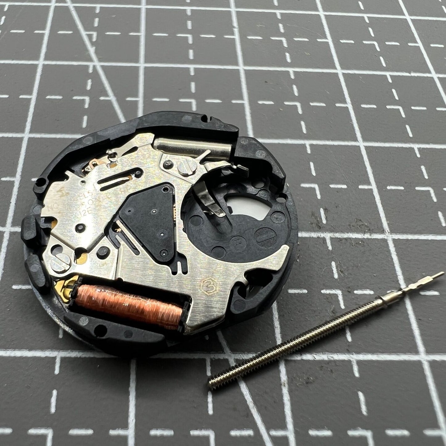 Hattori Epson TMI VX12 quartz watch movement with date at 3, Japan-made precision components for durability.