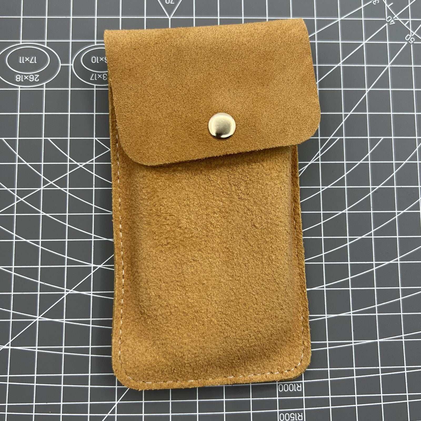 Brown Cowhide watch storage bag, soft-lined travel pouch protecting single watch securely.