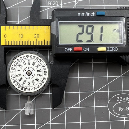 Miyota NH36A automatic watch movement with white dial, blue lume, and triple crown for precise time setting.