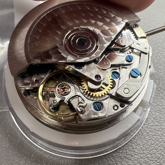 Chronograph watch accessory with ETA 7750 movement, white dial, single calendar at 6, second hand at 9.