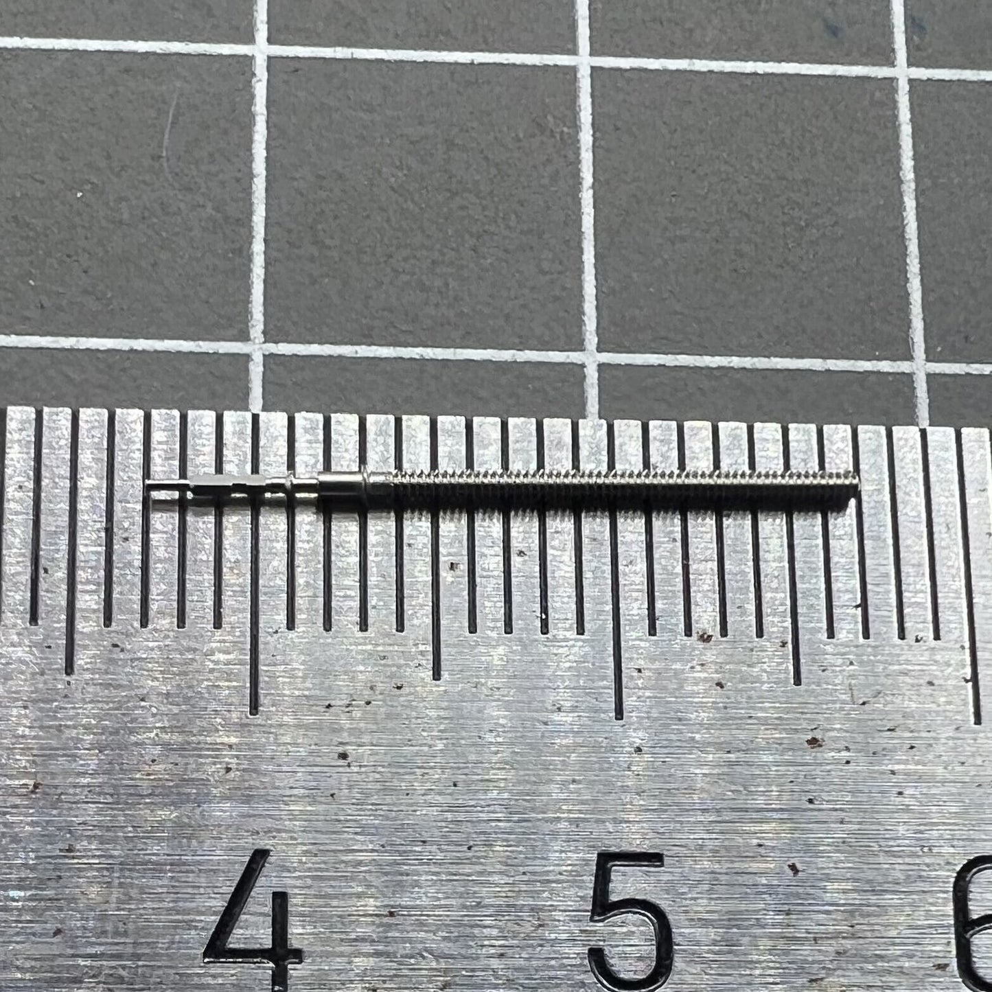 Watch winding stem VX12E, spare part for precise watch repair and maintenance.