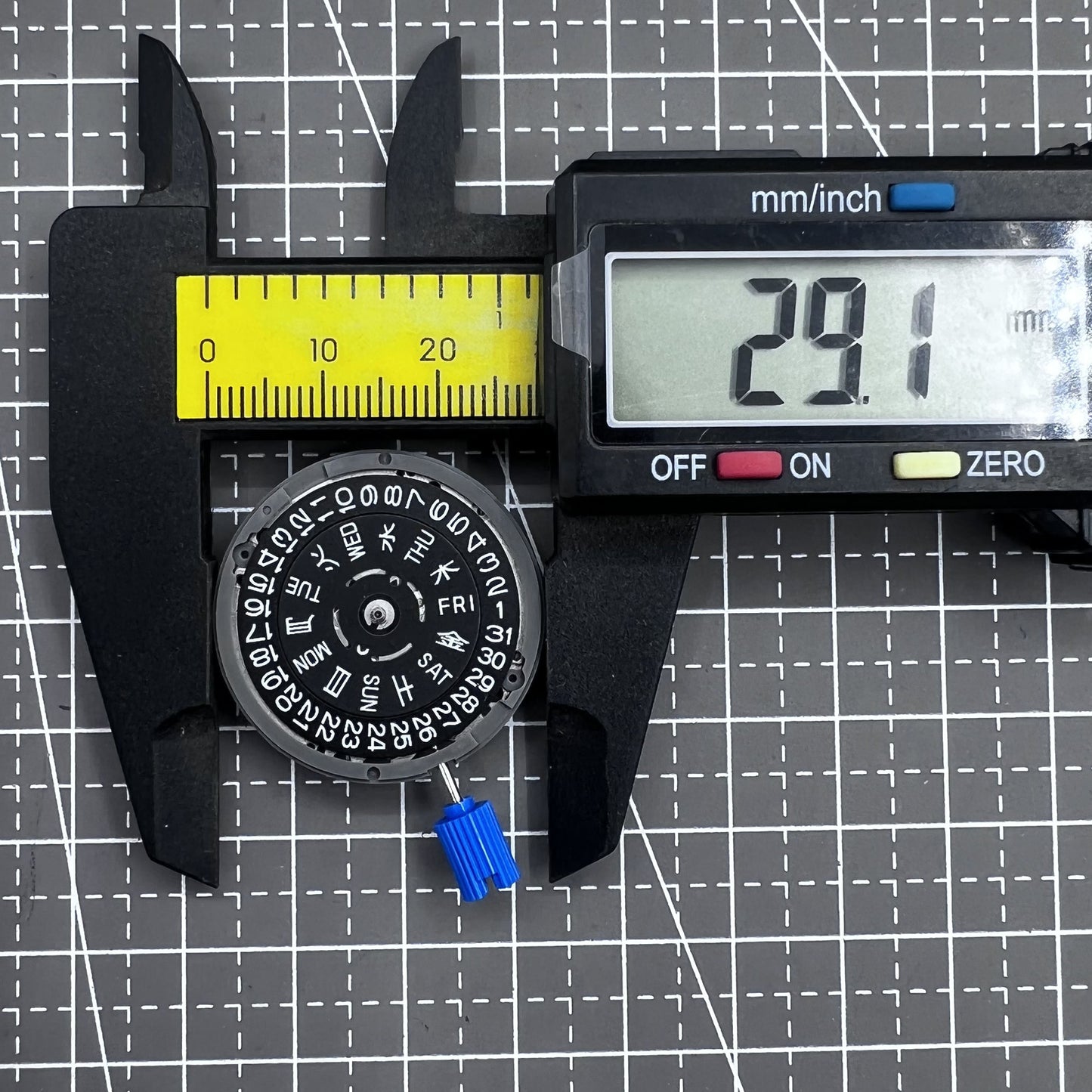 Seiko NH36A automatic watch movement with black finish and green luminescent markers, crown at 3:80 position.