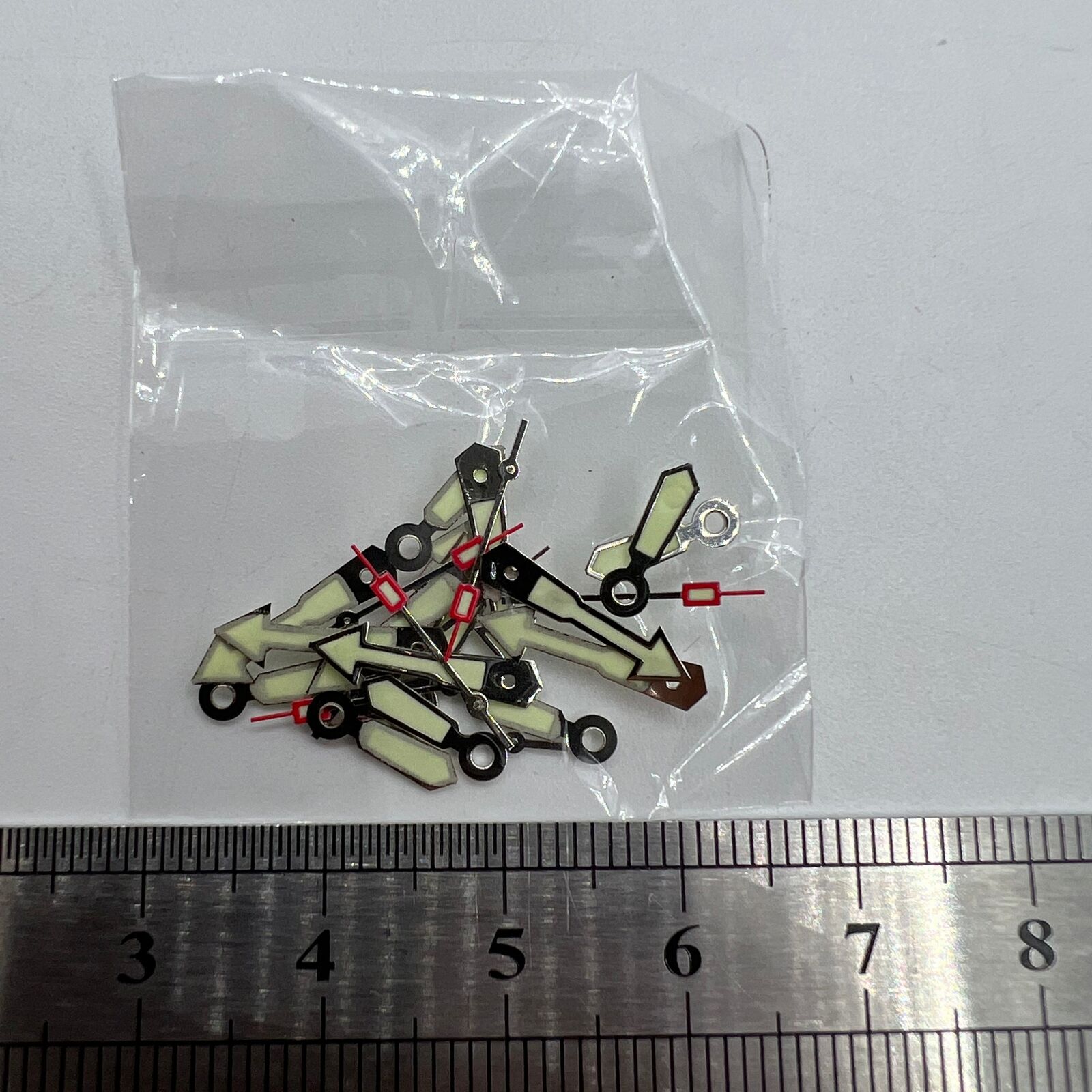 Arrow-shaped silver trim green lume watch hand for Miyota 2035 series, precise timekeeping accessory.