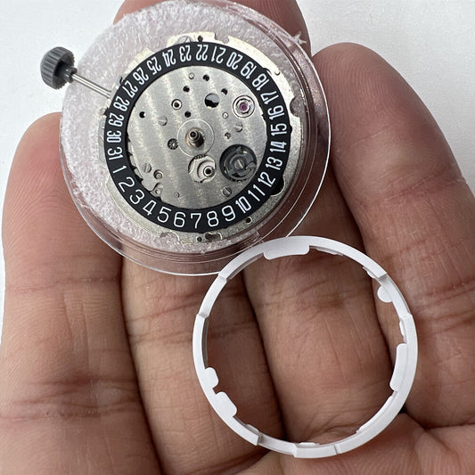 Miyota/Citizen 8215 automatic watch movement with black dial and date at 6 o'clock, Japan made.