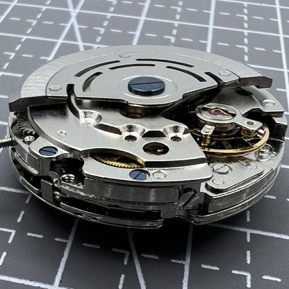 Close-up of DG2813 automatic watch movement with three large hands and small seconds at 6 o'clock, no calendar.