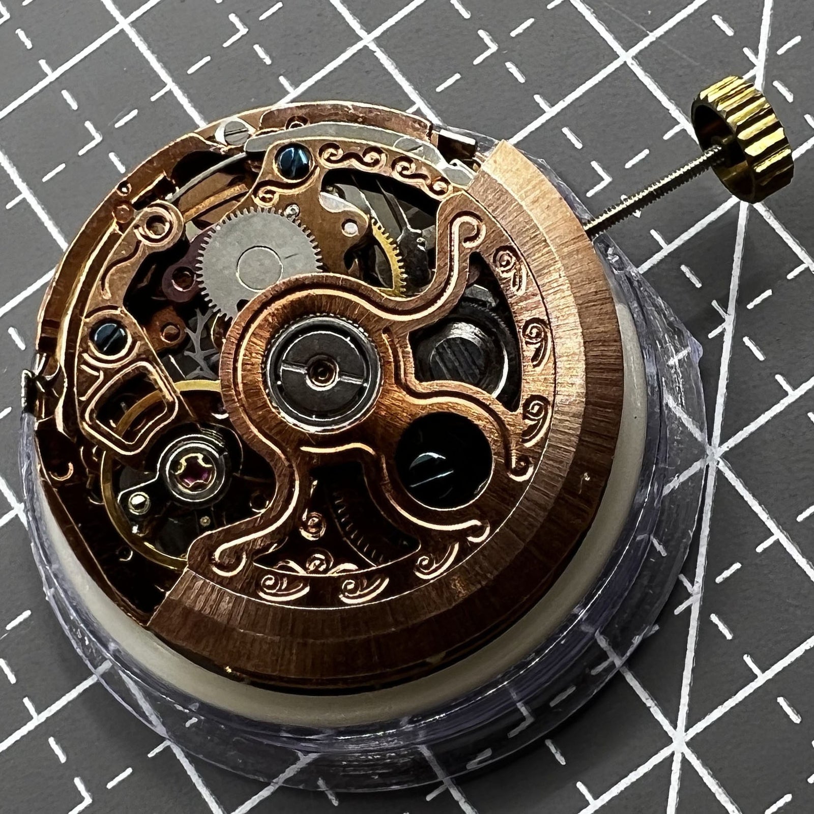 Hollow rose gold watch with mechanical movement, 4 subdials, and 7 hands, elegant design.