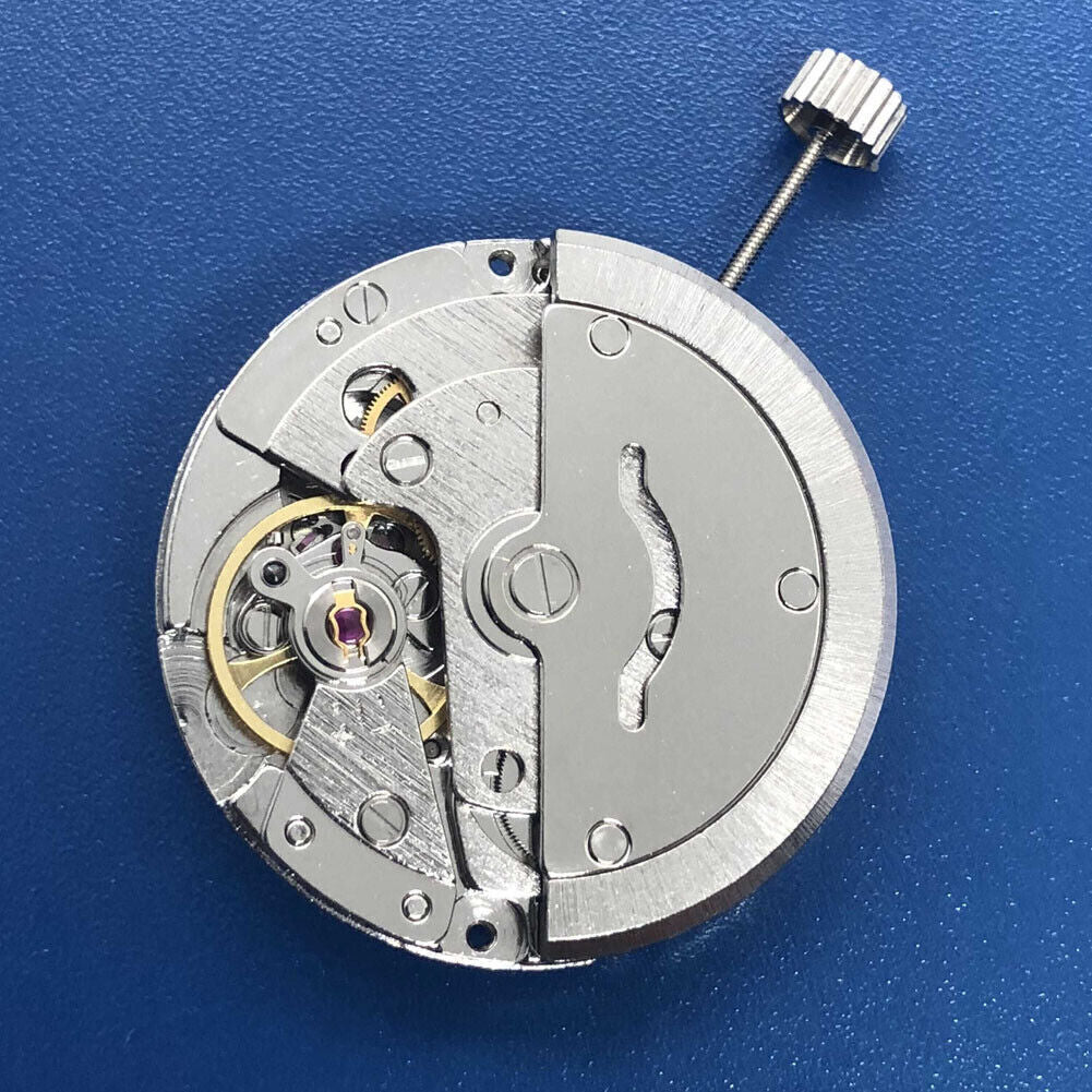 Tian Jing DG2813 automatic watch with silver dial, mechanical movement, and day-date display.