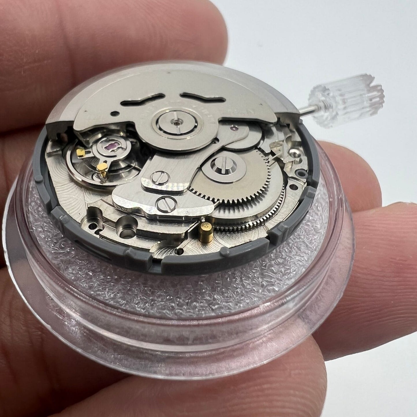 Black NH36A automatic watch movement with Roman wheel, crown at 3 o'clock, precision mechanical.