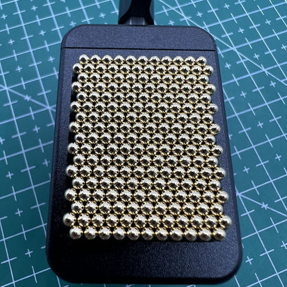 Universal metal movement holder with beads by Generic, fits all watch shapes for secure repair tasks.