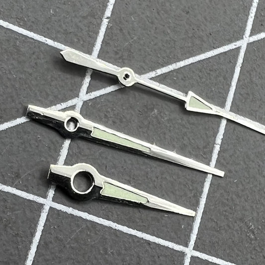 Luminous silver-trimmed watch hands for Miyota 2035 quartz movement, enhancing visibility and style.