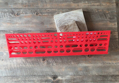 Wall-mounted tool board organizing screwdrivers and pliers for efficient workshop storage.