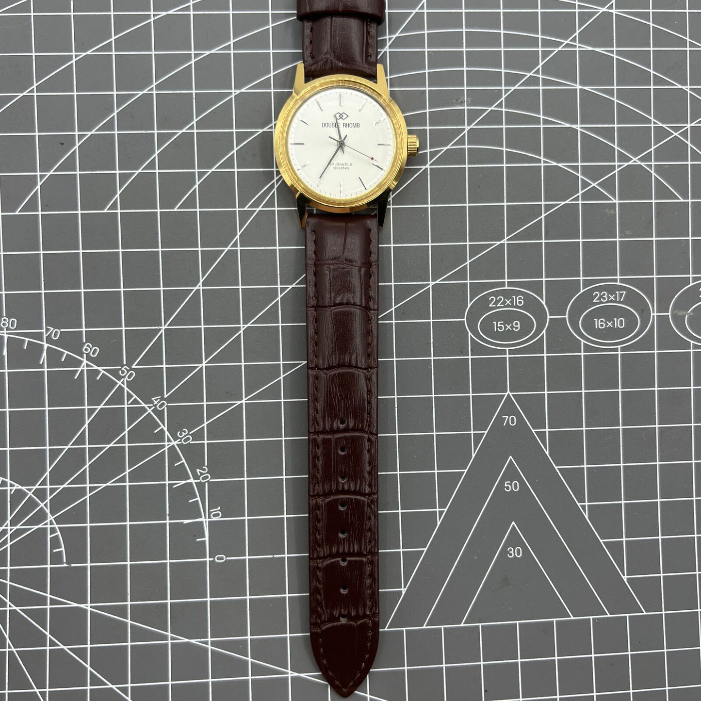 Beijing Double Rhomb mechanical watch with golden case, silver nail markers, and elegant classic design.