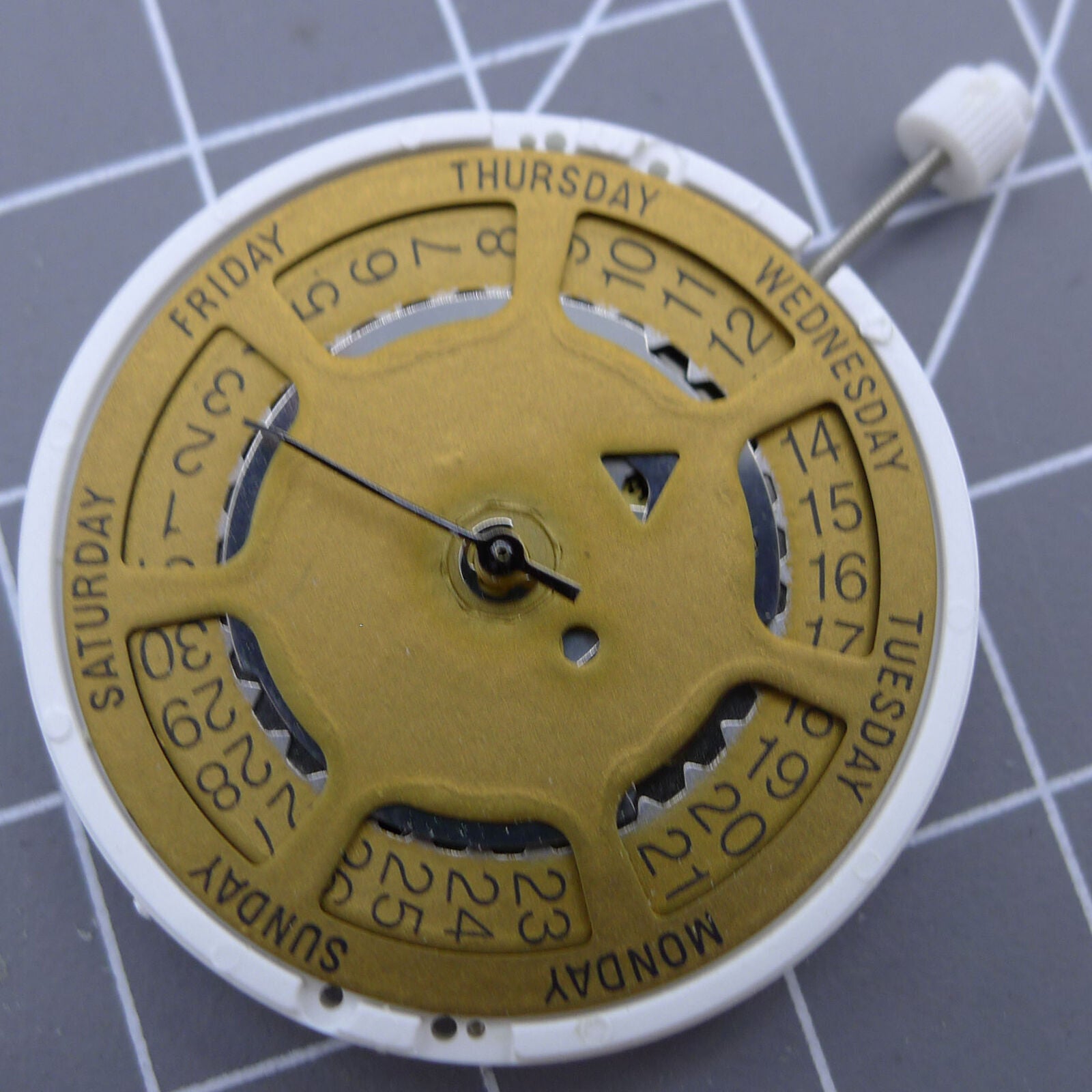 Golden dial ISA 1198 watch accessory with quartz movement and day-date feature at 3 o'clock position.